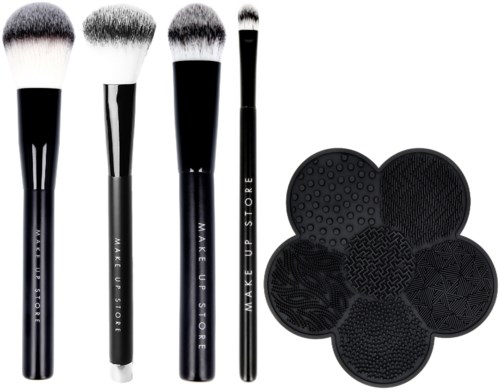 A set of makeup brushes and five black textured makeup sponge pads. The brushes vary in size and shape.