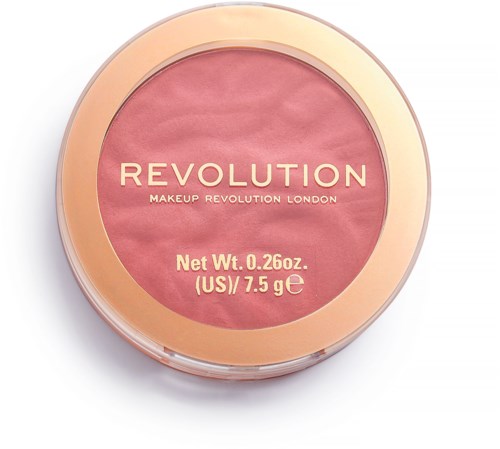 En rund makeup-produkt med rosa färg, guld kant och märket 'Revolution' på locket.
