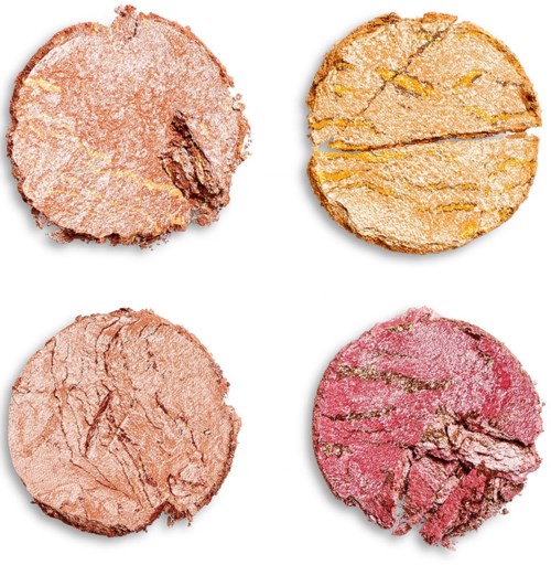 Four round, different colored cookies with cracks and toppings, arranged in a square, on a white background.