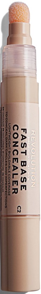 En beige sminkstång med svampstift, märkt 'Fast Base Concealer' från Revolution, stående vertikalt.