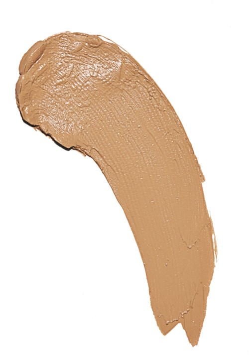 Ett beige makeup-produk, troligen foundation eller concealer, på en vit bakgrund. Det är formad som ett penseldrag.