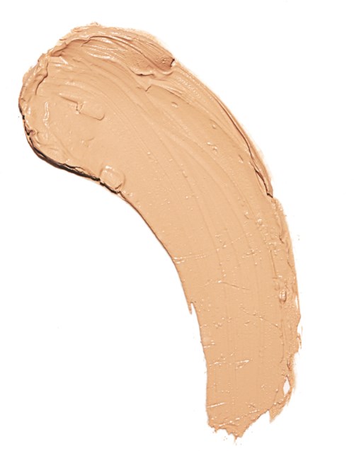 Krämig beige makeupraspning på vit bakgrund.