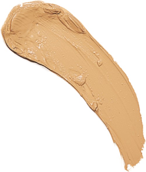 En beigefärgad krämig makeupprodukt utbredd i en böjd form.