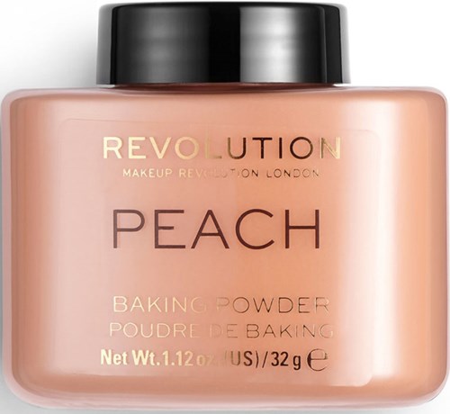 Ett peach-färgat sminkbakpulver med svart lock. Etiketten säger 'Revolution Peach Baking Powder'.