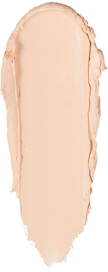 En smet av ljus beige makeup eller concealer med en lätt ojämn kant.