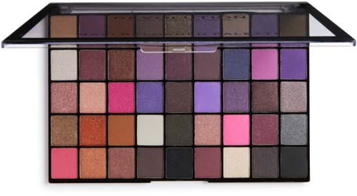 A large eyeshadow palette with many colors, including pink, purple, brown, and black, arranged in rows.