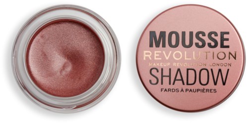 Ett litet glas med skimrande rosa-brun skugga och rund lock med texten "Shadow" och "Revolution".
