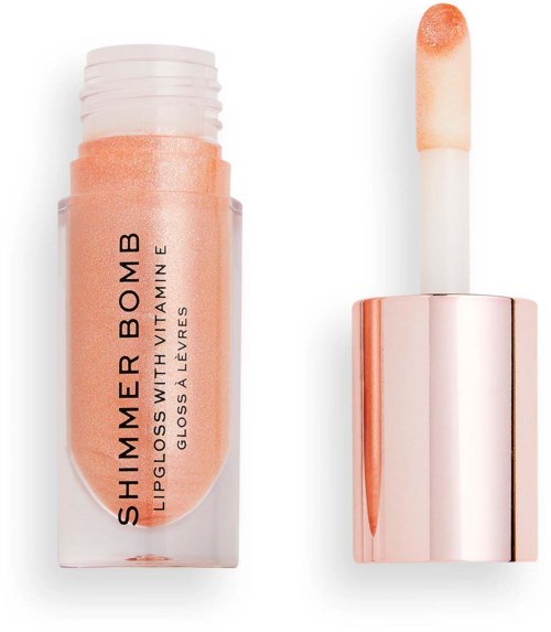Lippen-Glanz mit Pfirsichfarbenem Schimmer. Tube mit schwarzem Text und roségoldenem Deckel. Applikatorschwamm neben Tube.