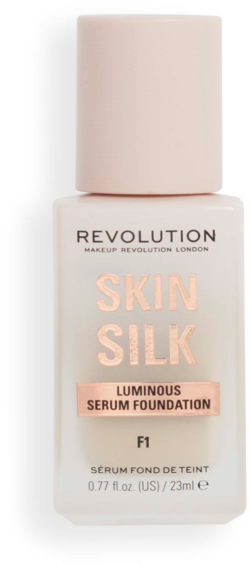 A bottle of makeup foundation labeled 'Skin Silk' from Revolution, with a pink cap and light-colored body.