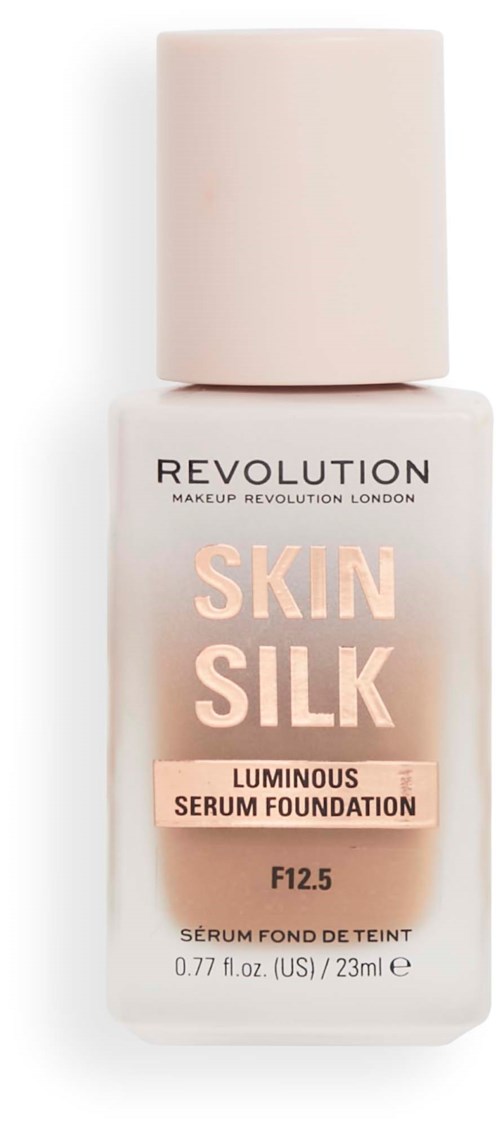 En foundationflaska märkt 'Skin Silk' med en ljus beige färg och vit kork.