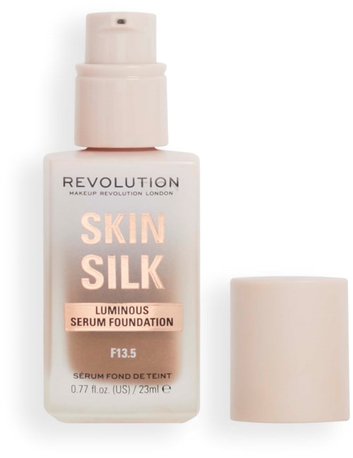 Eine Flasche mit der Aufschrift 'Skin Silk Luminous Serum Foundation' mit Sprühkopf und separatem Deckel.