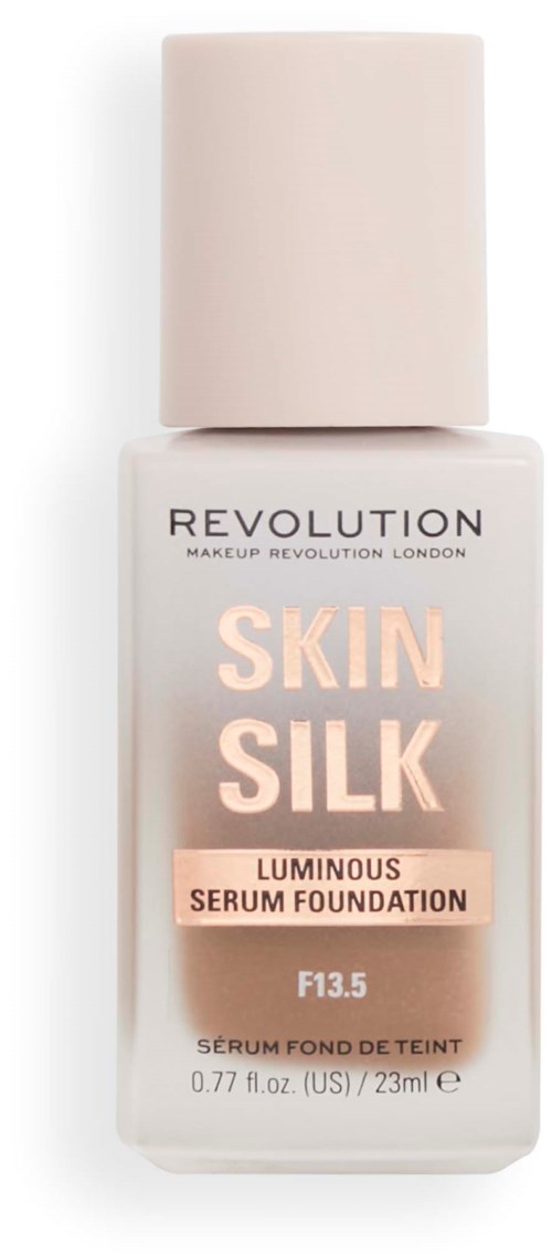 Eine weiße Foundation-Flasche mit beigem Deckel, beschriftet 'Revolution Skin Silk Luminous Serum Foundation'.