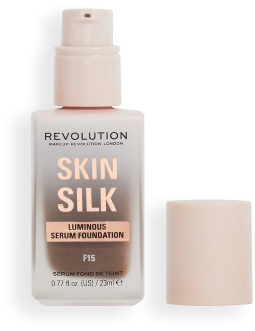 Eine weiße Flasche mit Revolution Skin Silk leuchtender Serum-Foundation mit Pumpe und Deckel.