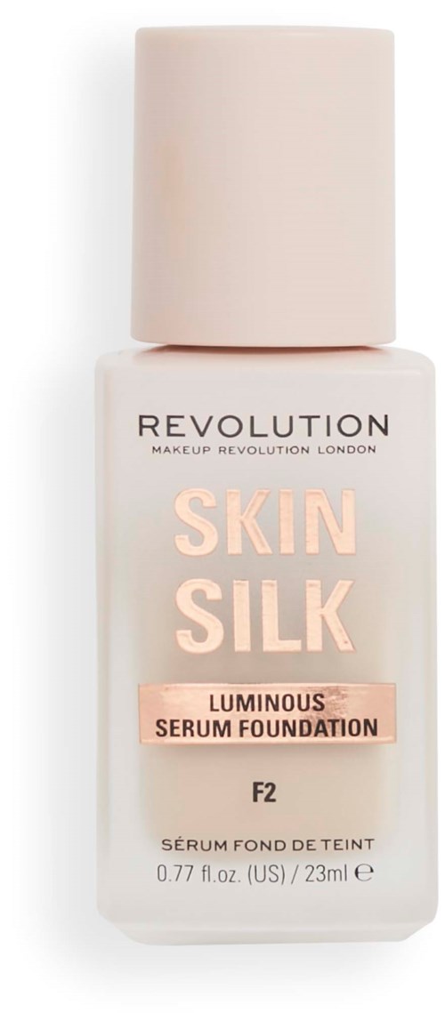 Flaska med Skin Silk Luminous Serum Foundation från Revolution, ljusrosa och vit flaska, med krämfärgad lock.