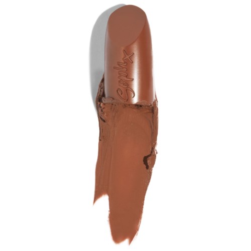 A brown lipstick with the brand name 'Syrix' visible, partially smeared with lipstick. Nothing else in the image.