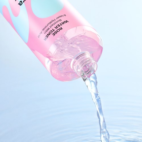 A pink transparent bottle labeled 'WATER OF LIFE' pours clear liquid into water.
