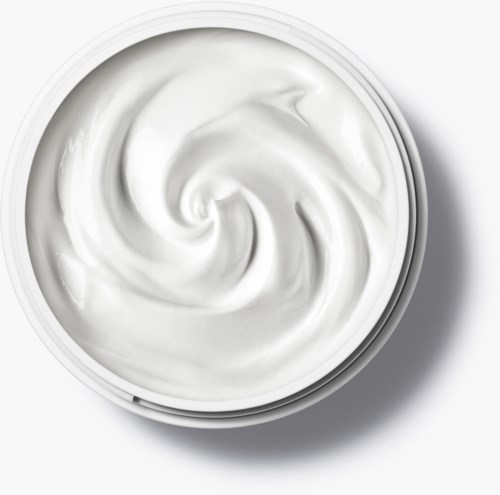A container filled with white, creamy yogurt, viewed from above on a white surface.