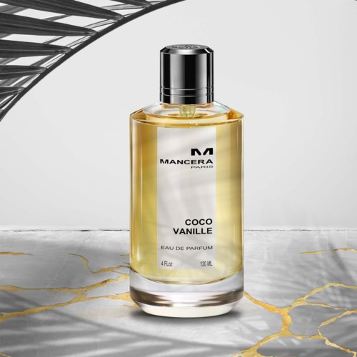 En parfume flaske mærket Mancera Paris, Coco Vanille, med gul væske, sølvkap, på marmoroverflade.