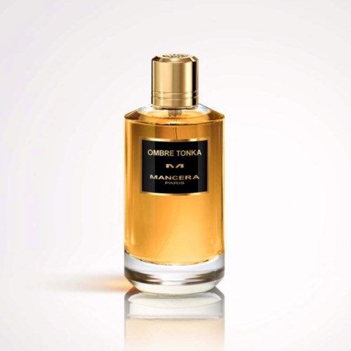 En parfymflaske med guldkapsel og sort label. Labels siger OMBRE TONKA MANCERA PARIS.