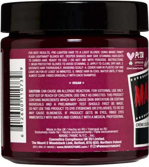 Ein kleiner Behälter mit Haarfarbe, Anweisungen und Warnhinweisen auf dem Etikett, inklusive vegan und tierversuchsfrei, mit schwarzem Deckel.