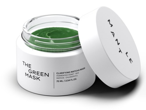 Öppen burk med grön ansiktsmask och vit lock, etiketten säger "The Green Mask."