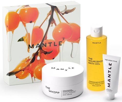 A set of skincare products with orange cherries design, including a shower oil, cream, and a small tube.