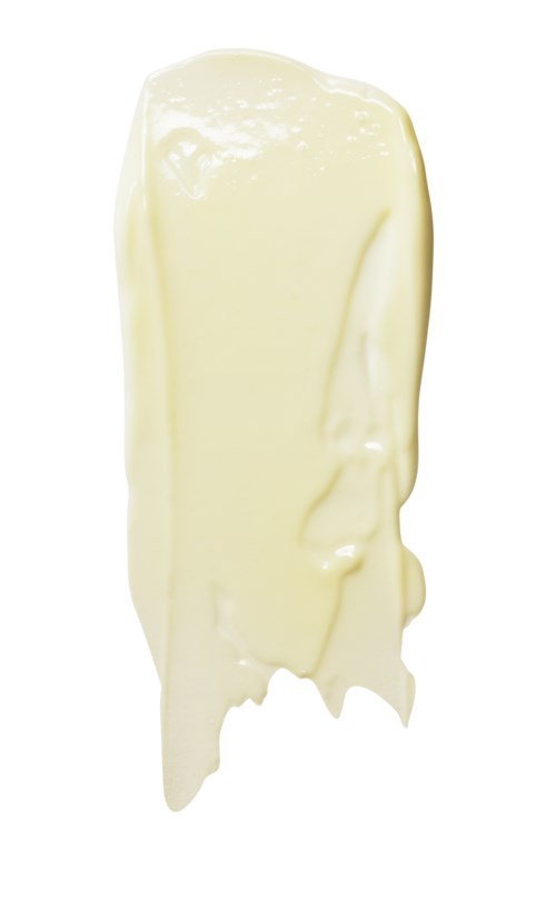 En stor sträng av smält vit choklad. Den är glansig och slät, hängande ner från toppen.