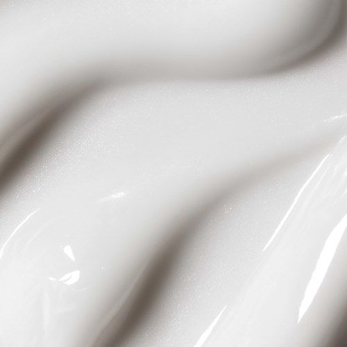 Close-up of white, shiny paint with smooth texture and glossy finish.