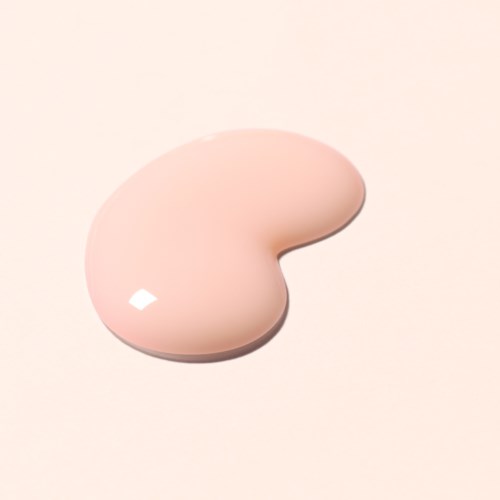 A beige, bean-shaped cosmetic sponge on a light background.