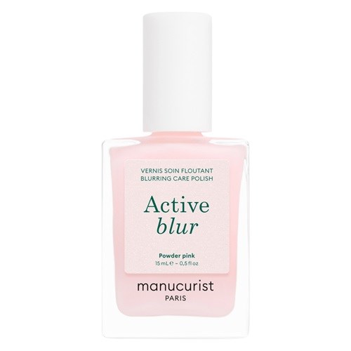 En flaske med rosa neglelakk med hvit kork, merket Active Blur Powder Pink av Manucurist.