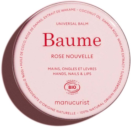 Round pink tin of organic hand, nail, and lip balm, labeled Baume Rose Nouvelle with ingredient information around the edge.