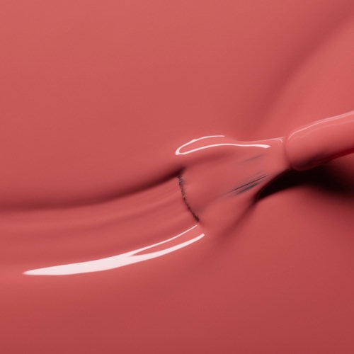 A pink liquid being poured into another, creating a splash and smooth flow.