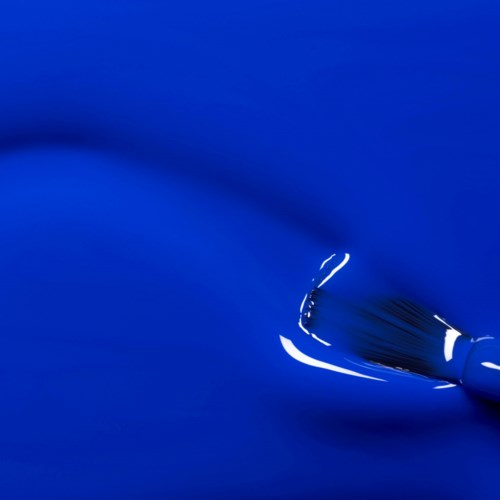 A blue surface with a silver needle, possibly part of a sewing or embroidery set.