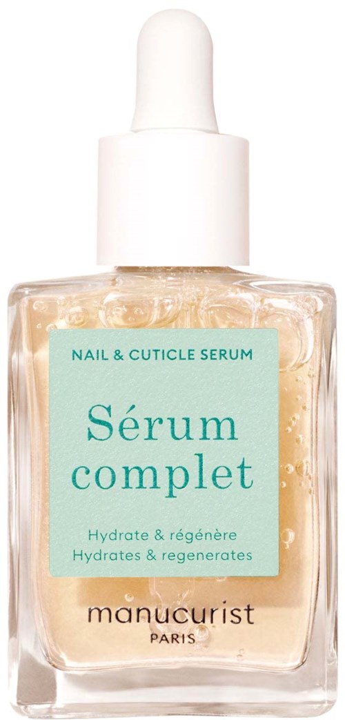 A clear glass bottle of nail and cuticle serum with a white dropper cap, label reads Sérum complet, hydrate and regenerate.