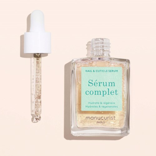 A clear glass bottle with a mint green label and a dropper cap containing nail and cuticle serum.