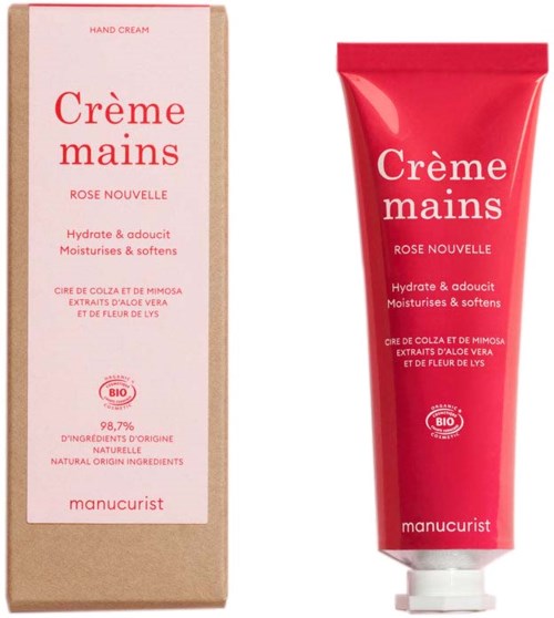 Rød håndcremetube med hvid låg ved siden af beige æske med pink og rød tekst til Manucurist håndcreme.