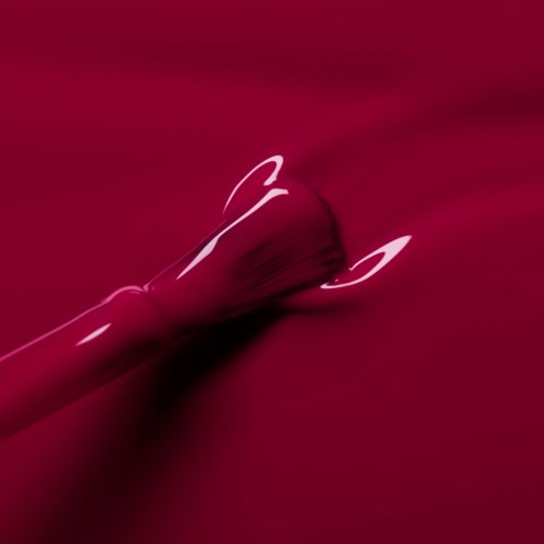 Pink and white glow on a red background, with a rounded object and light streaks.