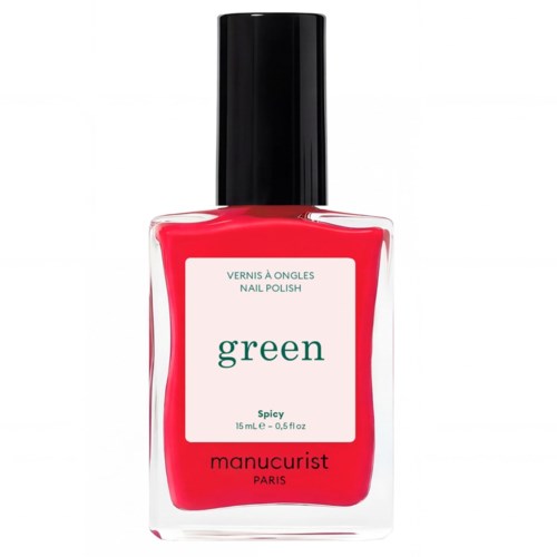 Jasnopomarańczowa butelka lakieru do paznokci z czarnym korkiem podpisaną green spicy od manucurist.
