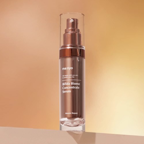 A skincare bottle labeled "Bifida Biome Concentrate Serum" with a pump and clear cap, standing on a surface.