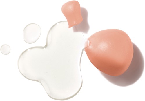 A broken egg with yolk and egg white spilled on a white surface.