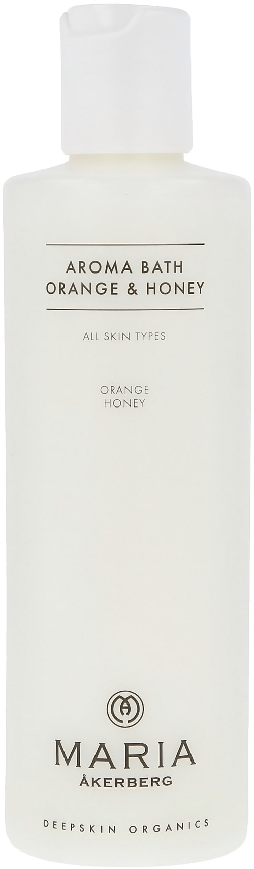 En vit flaska med lock, märkt 'Aroma Bath Orange & Honey' för alla hudtyper, av Maria Åkerberg.