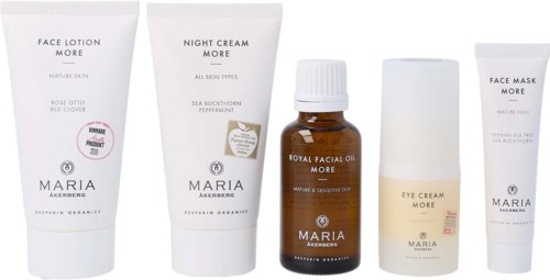 A set of skincare products including face lotion, night cream, facial oil, eye cream, and face mask, all in white and brown bottles.