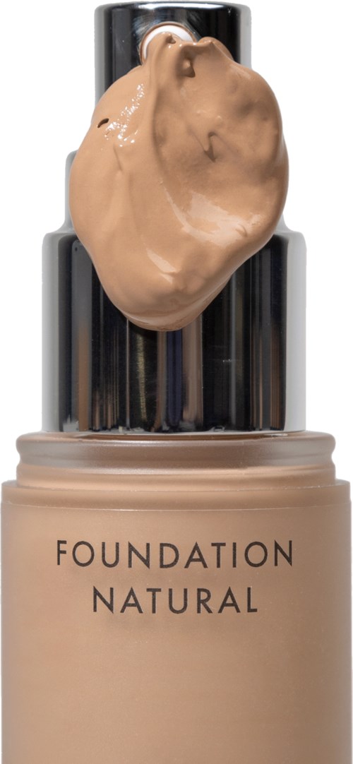 A bottle of foundation with a creamy dollop on the cap, labeled "Foundation Natural".