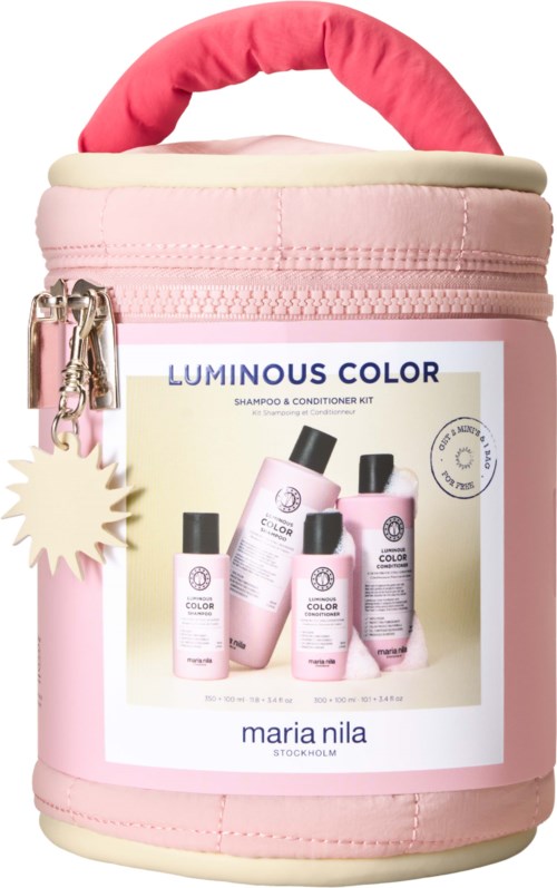 Różowa i kremowa torba z butelkami szamponu i odżywki, różowy uchwyt i zamek, reklamuje Luminous Color od Maria Nila.