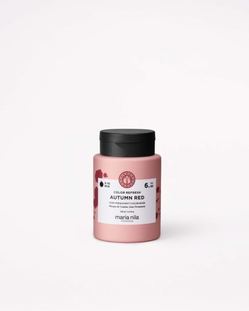 En liten rosa färgburk med svart lock, märkt 'Autumn Red', på en vit bakgrund.