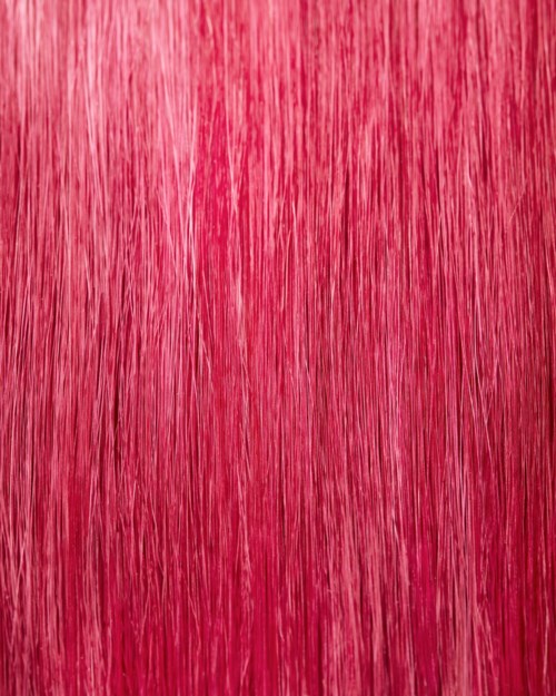 The image shows a vibrant red surface with fine vertical lines, looking like a textured material or surface.