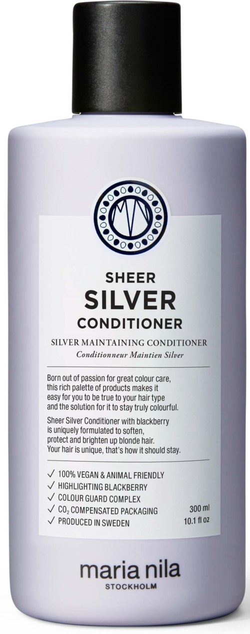 En vit flaska med silverbalsam har en svart kork och en etikett med blå och svart text.