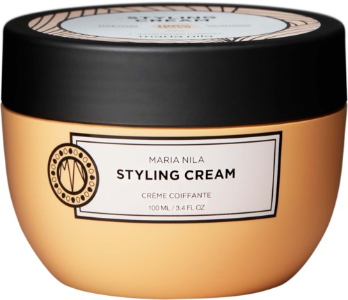 En rund krukke med svart lokk inneholder Maria Nila Styling Cream, som er merket på forsiden.