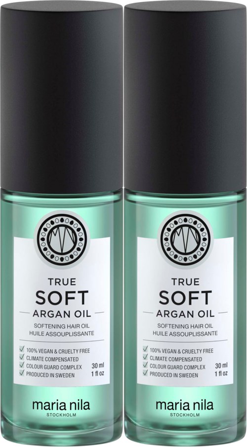 Dwie butelki miękkiego oleju arganowego do włosów, z czarnymi nakrętkami i przezroczystymi butelkami, oznaczone 'True Soft Argan Oil' od Maria Nila.