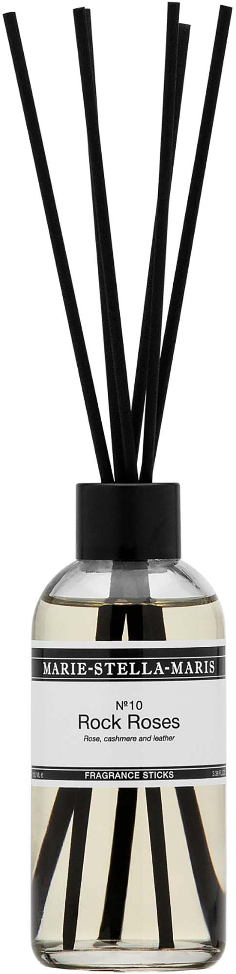 En doftdiffusor med etikett Marie-Stella-Maris Rock Roses och svarta pinnar. Enkel och modern design.